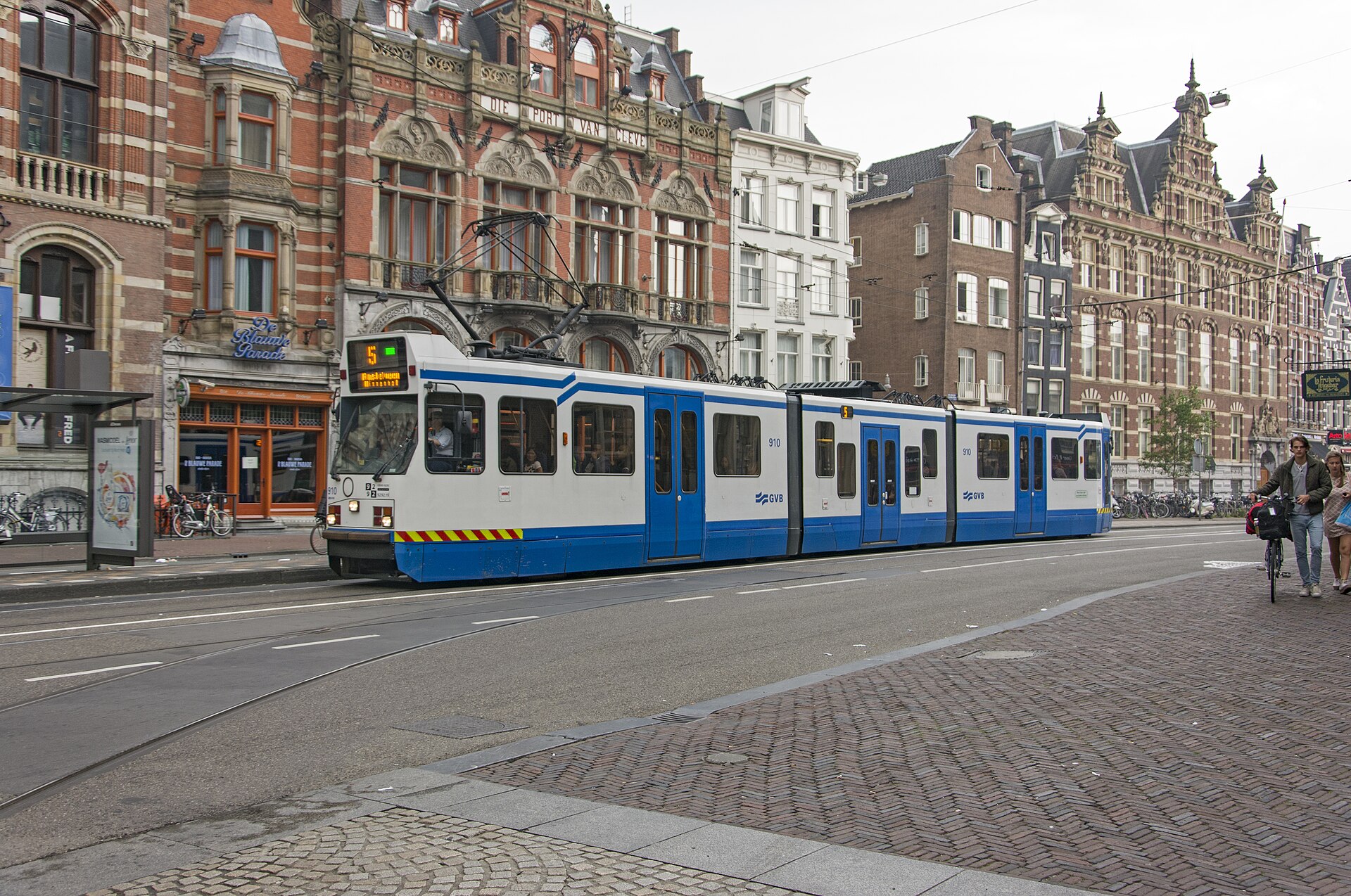 An Amsterdam GVB tram on a city-centre street.